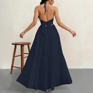 Elegant navy blue halter backless maxi dress featuring a chic tied bow and tiered skirt