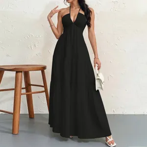 Elegant black halter-neck tiered maxi dress for a sophisticated summer evening look.