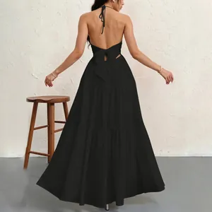 Elegant black backless halter neck tiered maxi dress showing rear detail and bow tie.