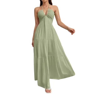 Elegant sage green halter neck maxi dress with tiered skirt and textured fabric detail.