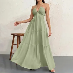 Full-body view of a sage green halter-neck tiered maxi dress with a ruched bodice detail.