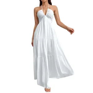 Detailed shot of an elegant white halter neck tiered maxi dress with crinkled texture