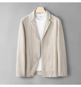 Lightweight men's linen blazer in beige, hanging against a grey wall