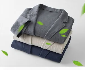 Close-up of three folded linen blazers in gray, beige, and navy with detailed fabric texture.