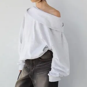 Detail view of a stylish light grey off-shoulder oversized sweatshirt for women