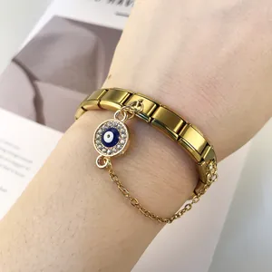Close-up of gold stainless steel Italian modular bracelet with evil eye charm.