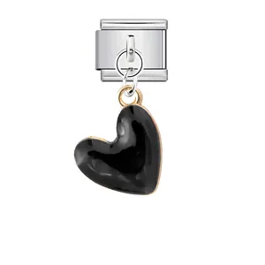 Macro view of black enamel heart pendant on a stainless steel Italian modular link