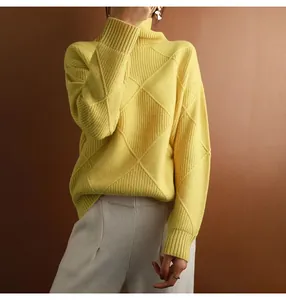 Detailed view of yellow argyle knit turtleneck sweater with soft and smooth texture