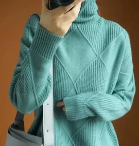 Detailed view of the teal diamond knit pattern on this soft high neck pullover sweater