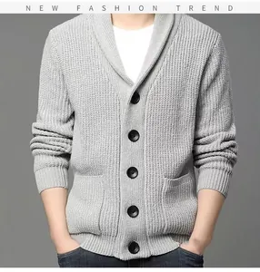 Close-up of men's grey thick knit cardigan with shawl collar and black buttons.