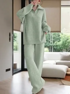 Women's mint green ribbed knit lounge set with half-zip sweater and wide leg pants.