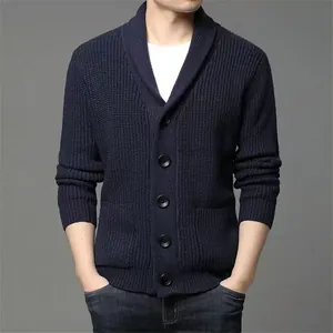 Close-up of navy blue shawl collar knit cardigan with textured weave and buttons