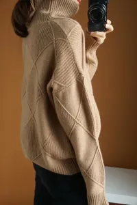 Close-up of camel argyle turtleneck sweater with soft knitted texture detail
