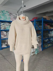 Oversized beige cowl neck knit sweater with lantern sleeves displayed on a mannequin
