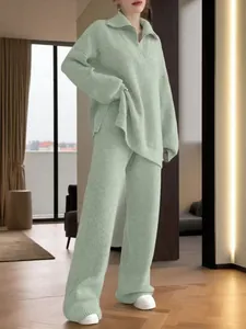 Detailed view of mint green oversized zip-up knit sweater and wide-leg pants set.