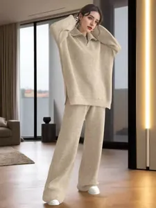 Full length view of a cozy two-piece beige knit set featuring a zippered sweater and pants