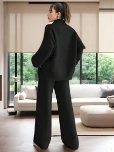 Elegant woman in a black ribbed knit loungewear set with wide-leg pants and sweater