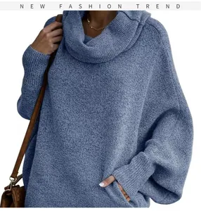 Close-up of blue oversized cowl neck knit sweater with stylish lantern sleeves.