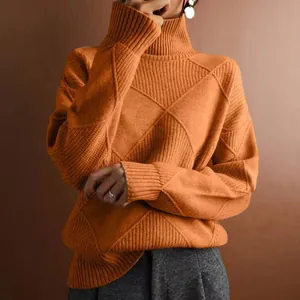 Detailed shot of an orange turtleneck knit sweater with a diamond pattern texture.