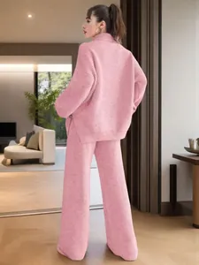 Rear view of this pink two-piece knitted set with loose sweater and wide pants.