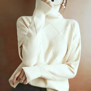 Detailed macro view of a cream diamond lattice turtleneck sweater with soft knit texture