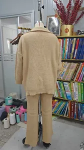 Rear view of a premium beige knitted two-piece set for women displayed on a mannequin