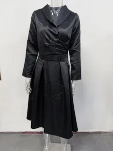 Detail view of an elegant black long-sleeve dress with a flattering wrap V-neck design.