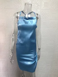Detail of a sexy light blue satin slip dress with a backless design and sleek finish.
