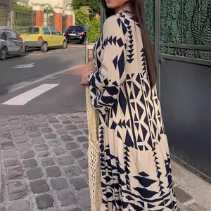 Elegant bohemian maxi dress featuring a bold black geometric print on a beige fabric.
