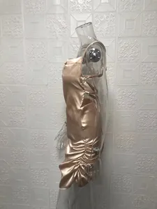 Detailed side view of a sexy champagne satin mini dress with back tie-up straps