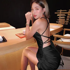 Close-up of black backless dress featuring elegant criss-cross lace-up straps.
