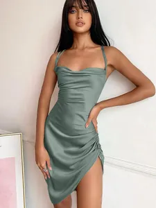 Detail of sage green satin cowl neck mini dress featuring side ruching and asymmetric slit