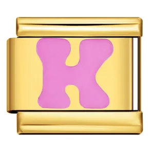 Detail of a gold-toned Italian modular bracelet charm with a pink enamel letter K