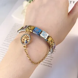Close-up of stainless steel Italian modular bracelet featuring an evil eye charm