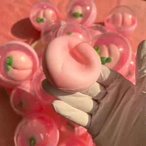 Close-up showing the soft texture of a pink peach slow rebound squishy stress toy