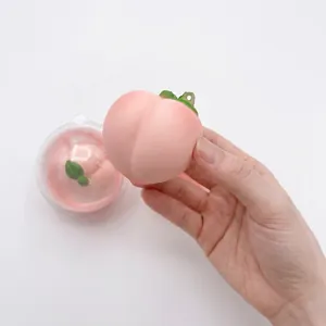 Peach-shaped slow rebound squishy toy with scent in a transparent gashapon ball