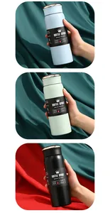 Detail van drie vacuümgeïsoleerde sportflessen in verschillende kleuren in de hand