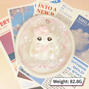 Gros plan d'un jouet squishy animal en silicone blanc, sac en dentelle rose, 82,8g