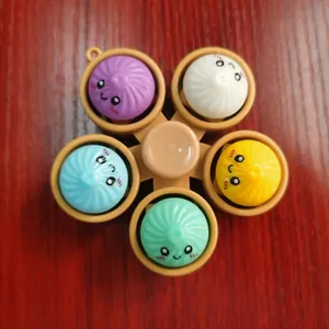 Detail view of colorful emoji bun fidget spinner keychain for stress relief