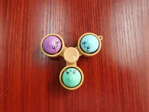Detailed view of colorful steamed bun fidget spinner featuring cute emoji expressions