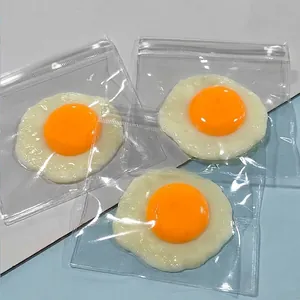 Detailed view of three cute fried egg shaped squeeze toys individually packed in clear bags