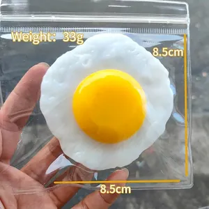 Detailed view of the 8.5cm fried egg squishy stress toy showing size and weight