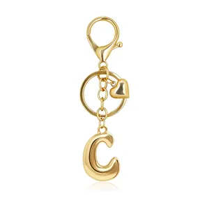 Macro detail of gold bubble letter C keychain with heart charm