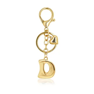 Detailed view of a gold bubble letter D keychain with heart charm and lobster clasp