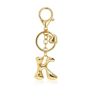 Detailed view of shiny gold bubble letter K keychain with heart charm.