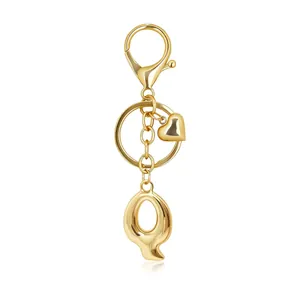 Gold-toned metallic keychain with a stylized bubble letter Q pendant and heart charm
