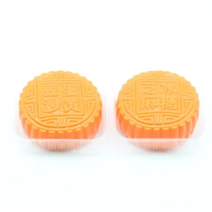 Detailed view of two traditional mooncake-shaped squishy toys for stress relief.