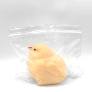 Macro detail of a yellow chick squishy toy packaged in a clear protective plastic bag