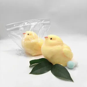 Detailed view of soft yellow TPR chick squishy stress toy with green leaves and bag