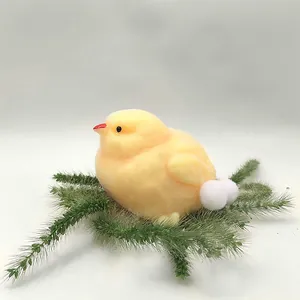 Detailed macro shot of a soft fuzzy yellow chick squishy toy resting on green grass